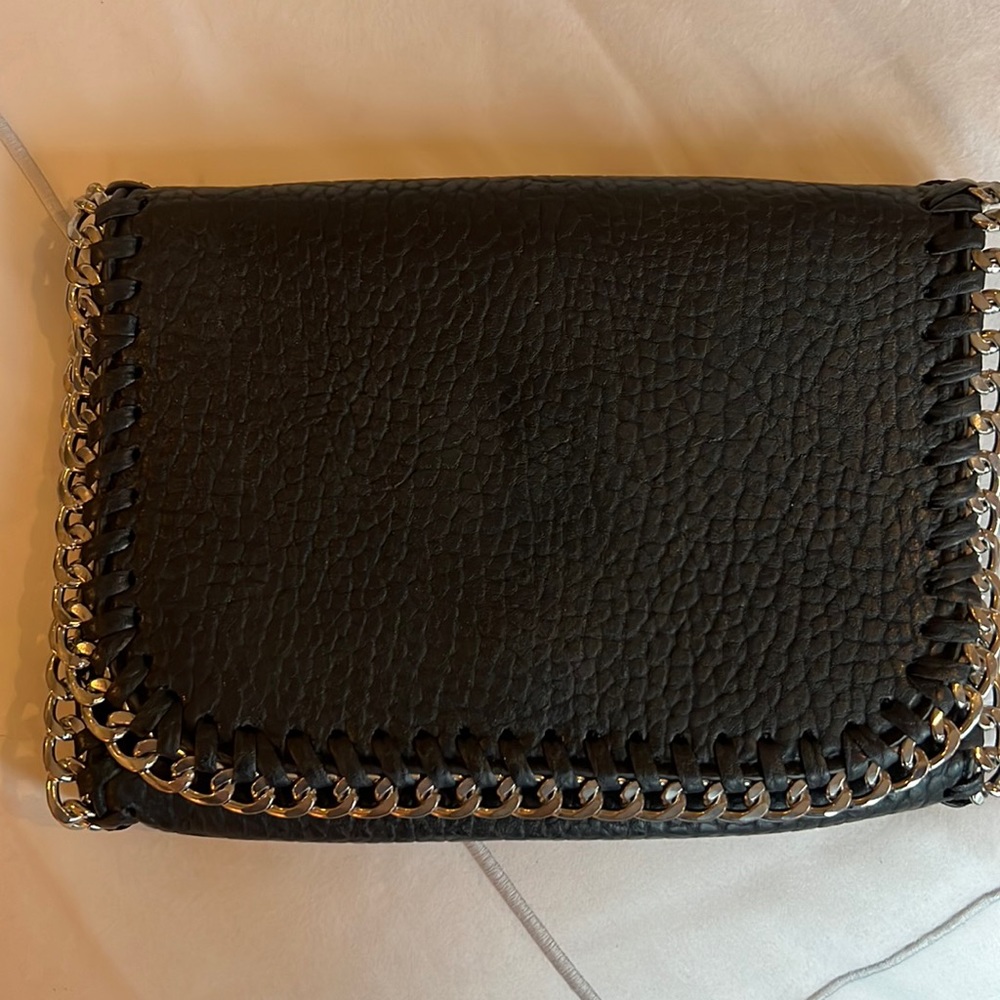 Black leather clutch handbag with silver metal chain trim